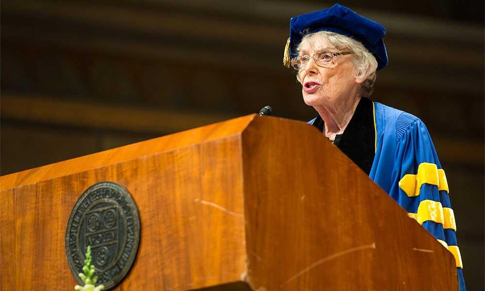 Dr. Ruth A. Lawrence ’49M (MD), ’58M (Res) at podium wearing graduation regalia